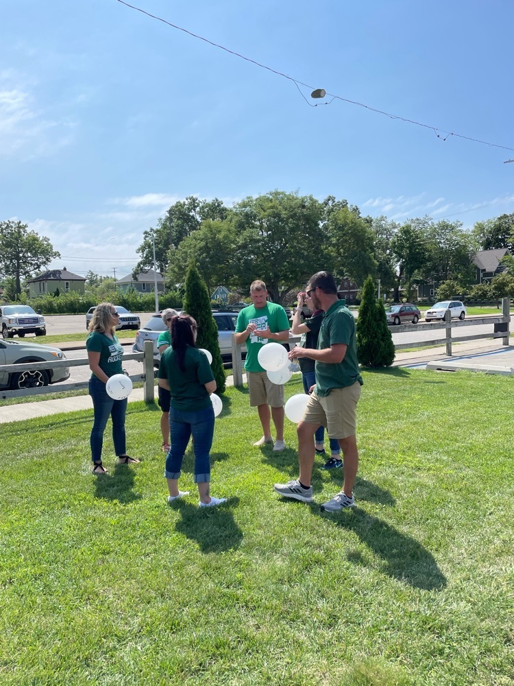 educators with balloons outside